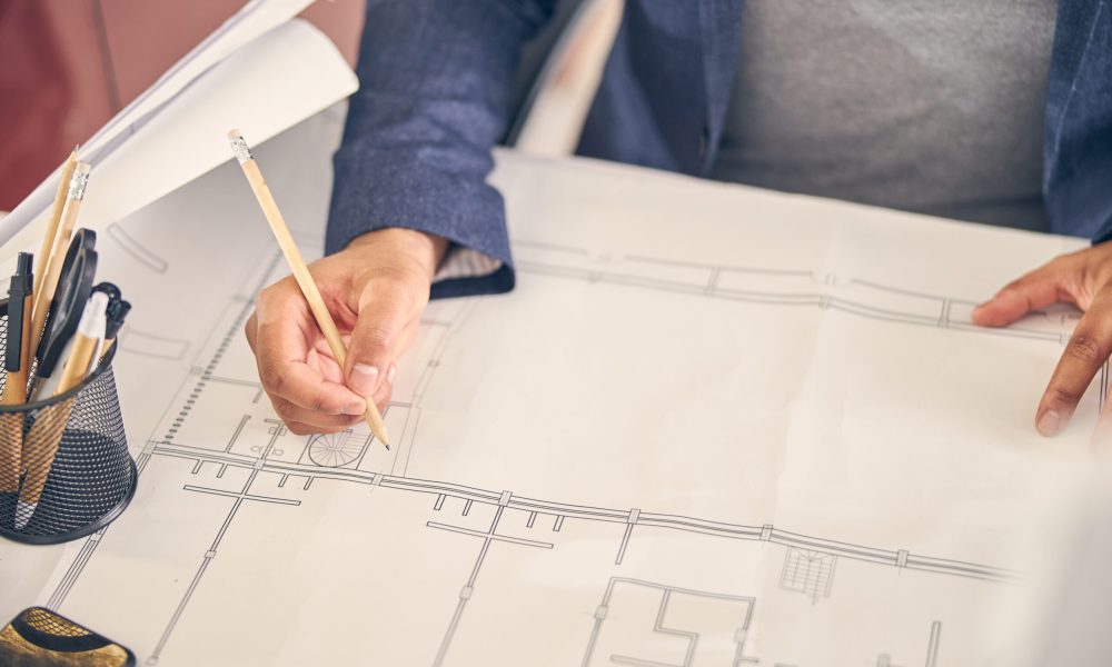 Professional architecture sitting at his workplace while preparing for project presentation