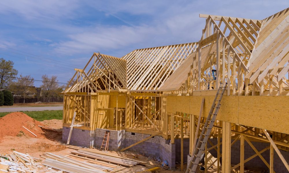 Home construction the frame of house beginning on unfinished roofing construction