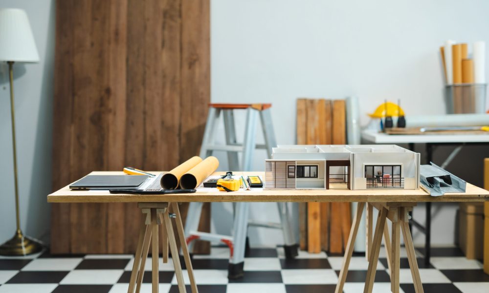 Construction house and building. workspace area. dof laptop computer and office construction on table in office blurred background, Architect concept.